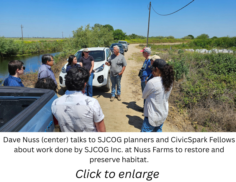 A group of people outside talking with a caption and \