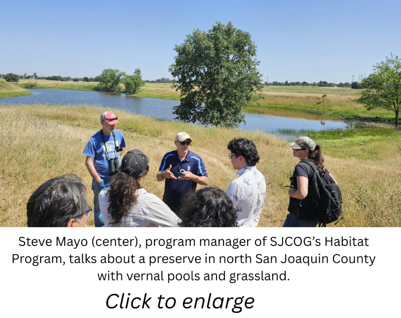 A group of people outside talking with a caption and \